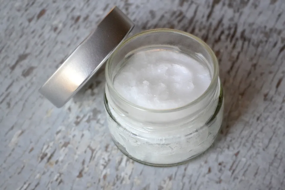 Natural skincare ingredients and a bottle arranged on a neutral background